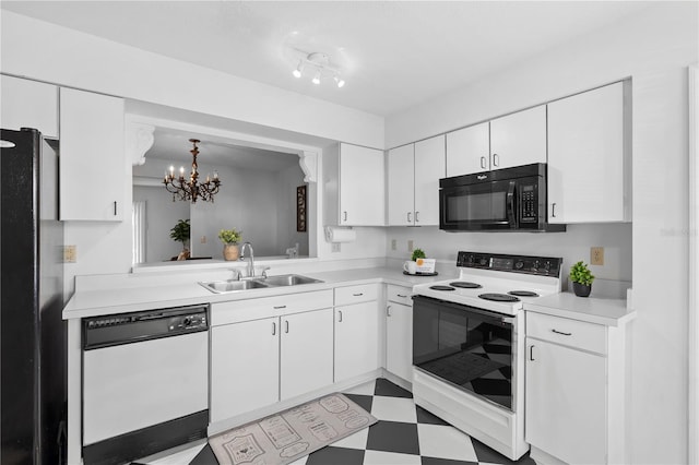 kitchen featuring sink, white cabinetry, a chandelier, pendant lighting, and black appliances