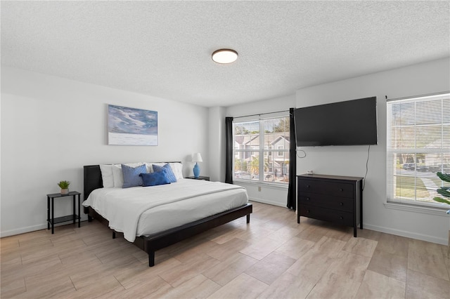 bedroom featuring a textured ceiling and light wood-type flooring