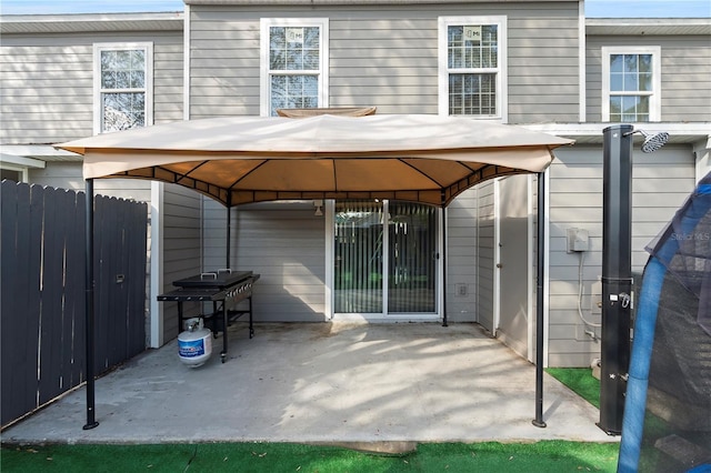 rear view of property with a gazebo and a patio area