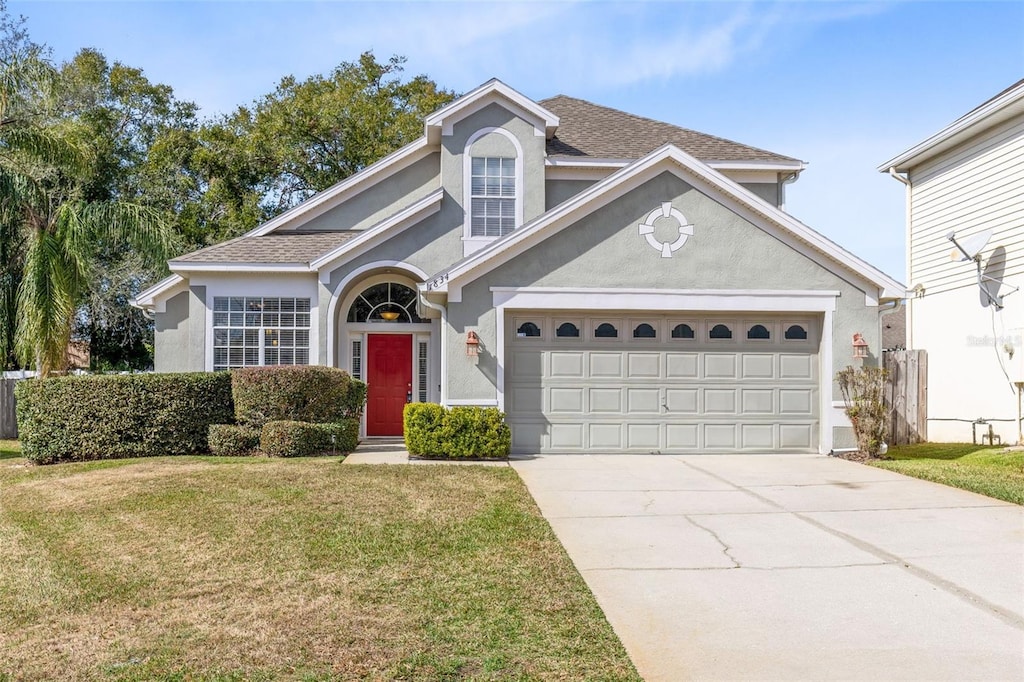 view of front property with a garage and a front yard