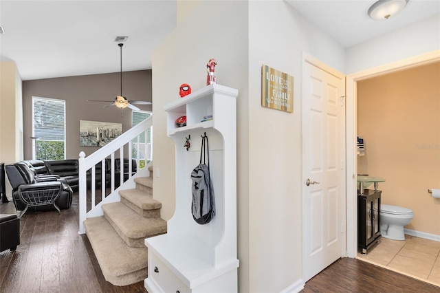 hallway with dark hardwood / wood-style floors and vaulted ceiling