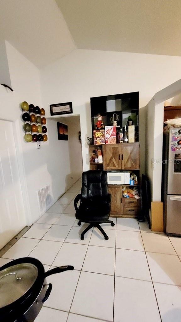 1417 Brookebridge Dr, Orlando, FL 32825 - home office with lofted ceiling, visible vents, and light tile patterned flooring