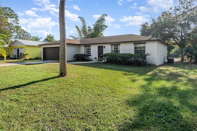 ranch-style house featuring cooling unit, a garage, and a front yard