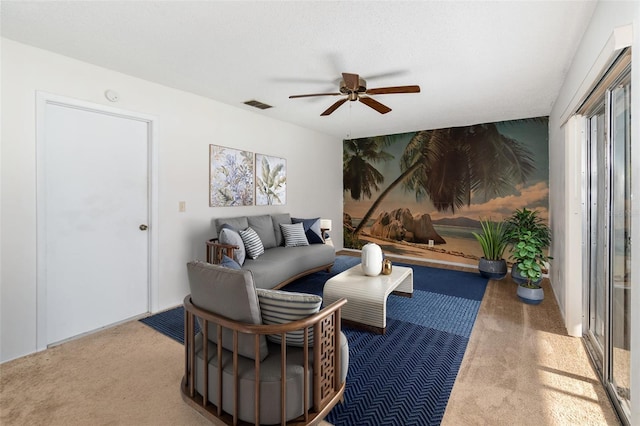 carpeted living room with a textured ceiling and ceiling fan