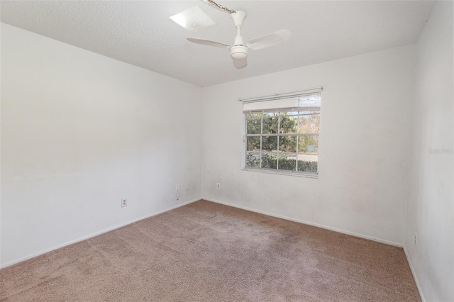 carpeted empty room with a textured ceiling and ceiling fan