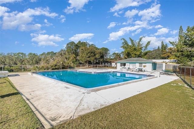 view of pool with a yard and a patio