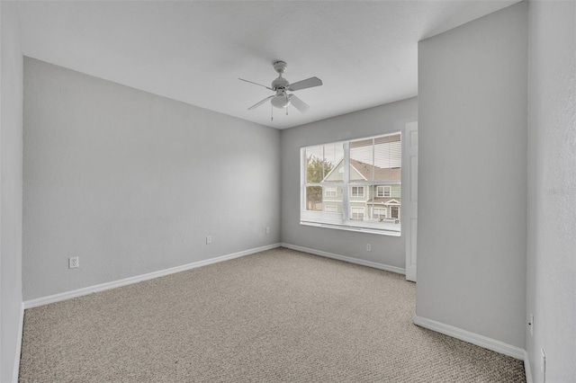 unfurnished room featuring light colored carpet and ceiling fan