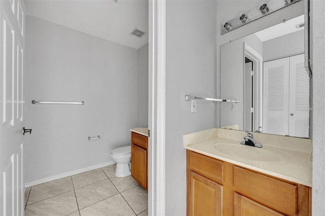 bathroom featuring tile patterned flooring, vanity, and toilet