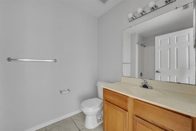 bathroom featuring vanity, a shower, tile patterned floors, and toilet