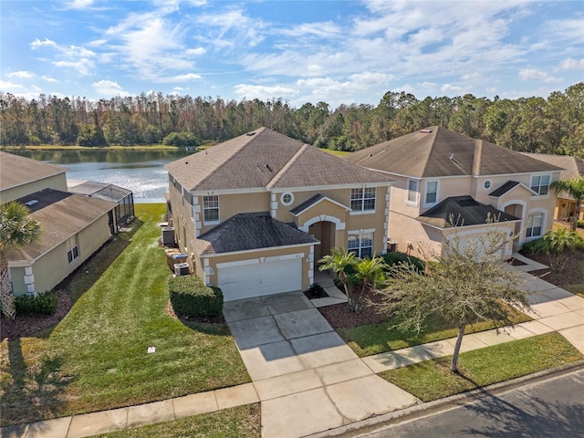 view of front facade featuring a garage, a front yard, and a water view