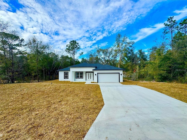 view of front of home featuring a garage and a front lawn