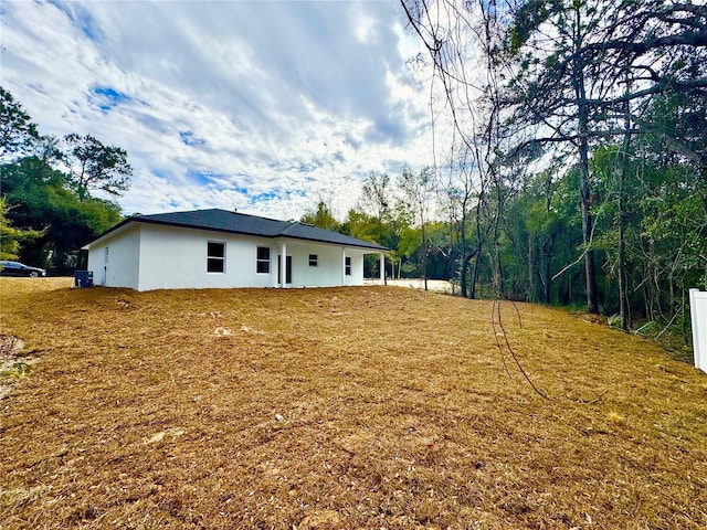 rear view of house with a yard