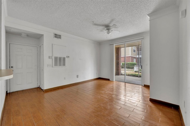 empty room featuring wood-type flooring, a textured ceiling, and ceiling fan