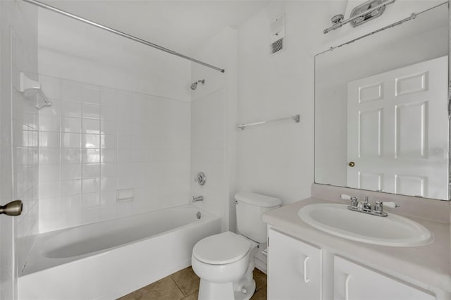 full bathroom featuring vanity, toilet, tiled shower / bath combo, and tile patterned flooring