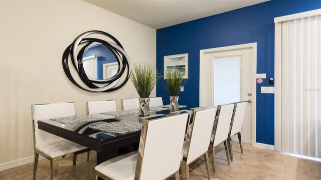 tiled dining room with a textured ceiling