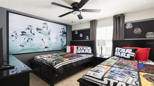 bedroom with ceiling fan, carpet, and a textured ceiling