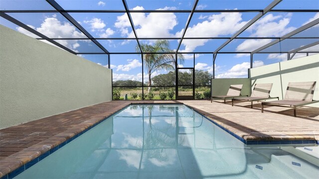 view of swimming pool with a lanai and a patio