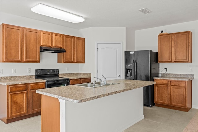 kitchen featuring sink, a center island with sink, and black appliances