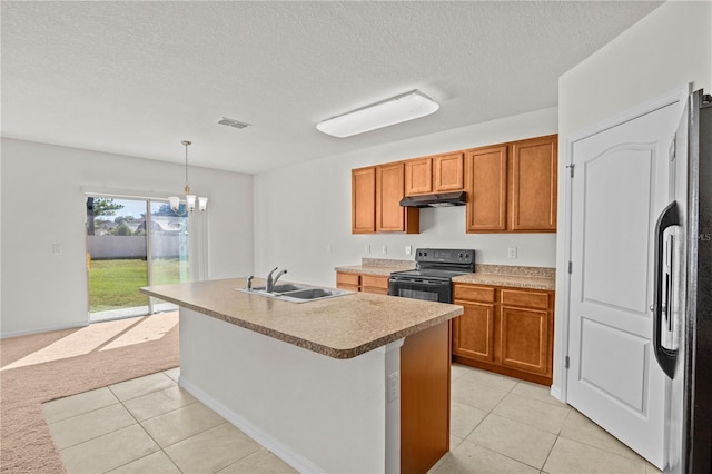 kitchen with sink, decorative light fixtures, a center island with sink, light colored carpet, and black appliances