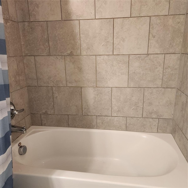 full bathroom featuring curtained shower and a bath