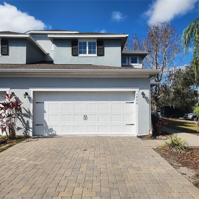 garage featuring decorative driveway