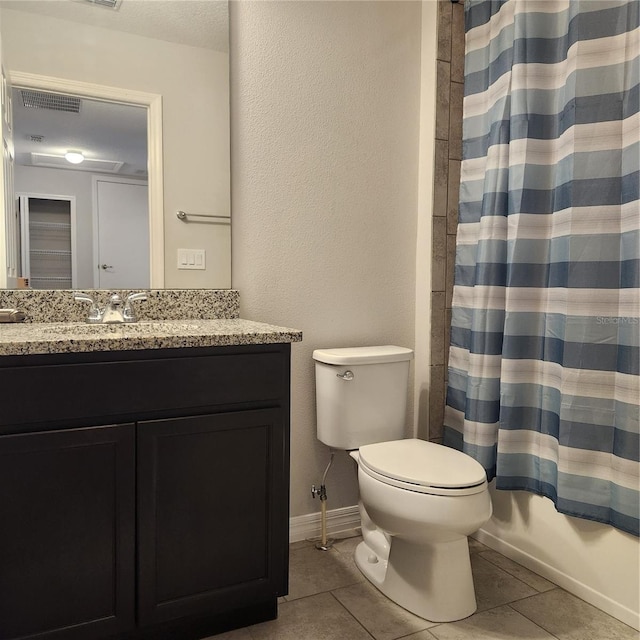 full bathroom with tile patterned floors, toilet, vanity, and baseboards