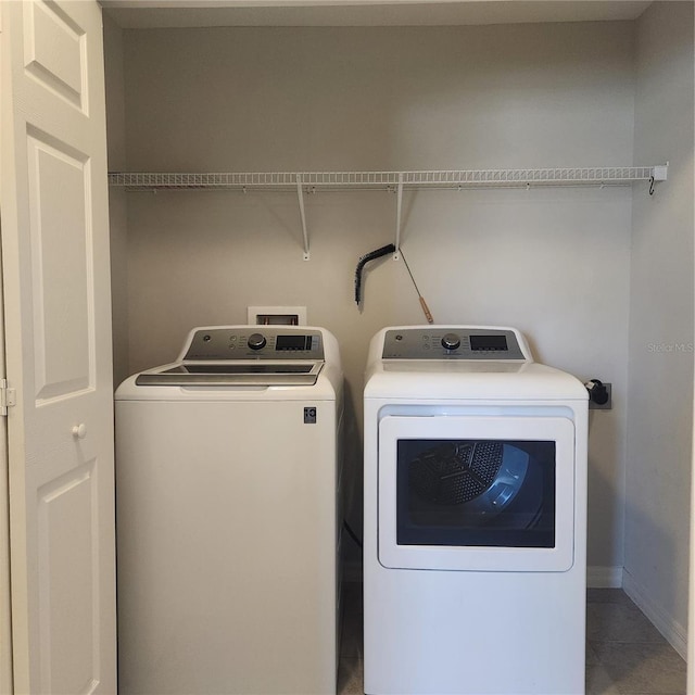 clothes washing area with washer and dryer and laundry area