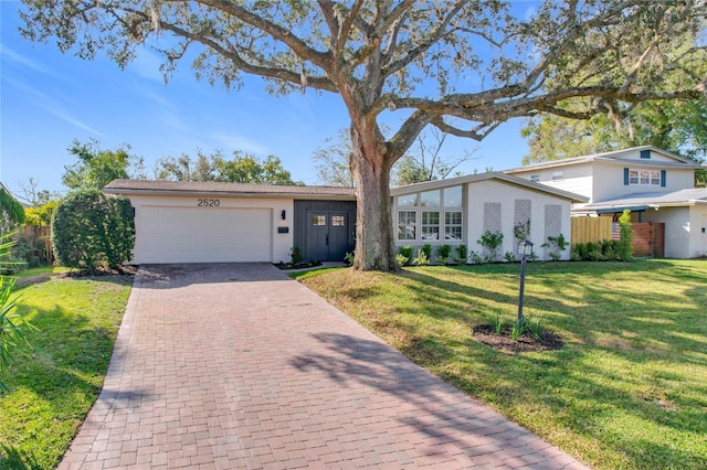 view of front facade featuring a garage and a front lawn