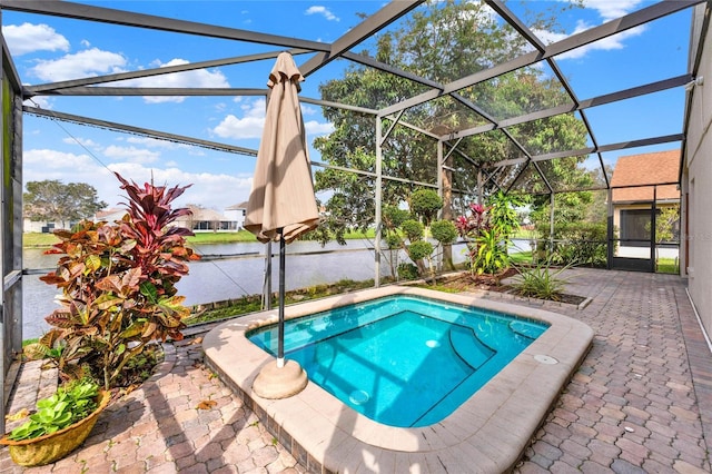 view of swimming pool with glass enclosure and a patio area