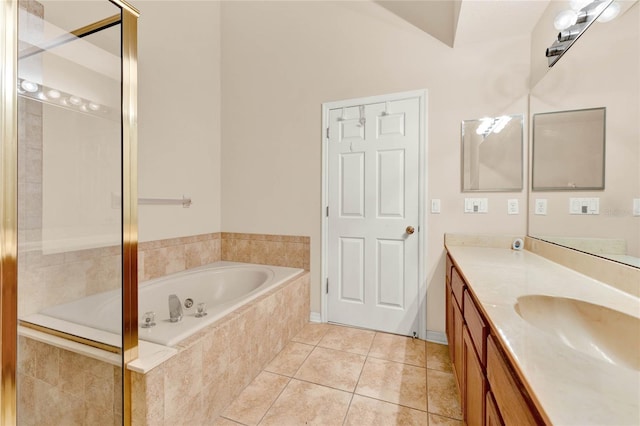 bathroom with tiled bath, tile patterned floors, and vanity