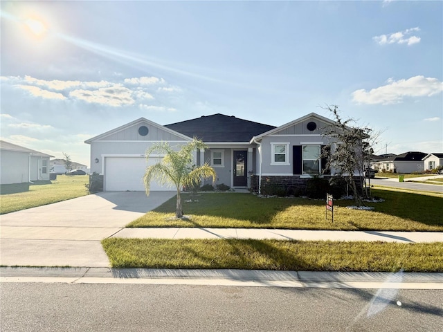 ranch-style home featuring a garage and a front lawn