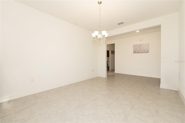 spare room with baseboards, visible vents, and a notable chandelier