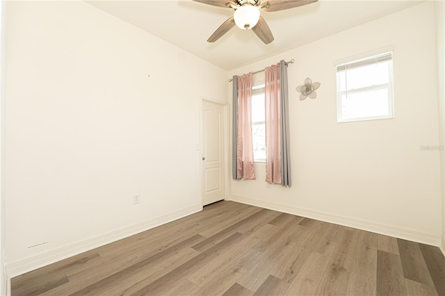 empty room with light wood-style flooring, baseboards, and ceiling fan