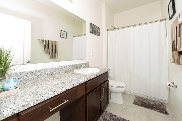 bathroom with toilet, vanity, and tile patterned floors