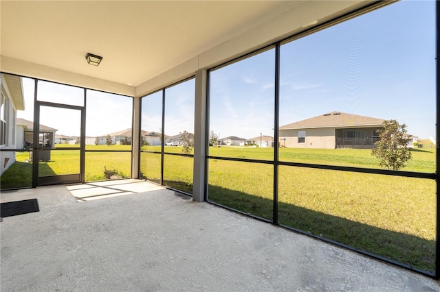 unfurnished sunroom with a residential view