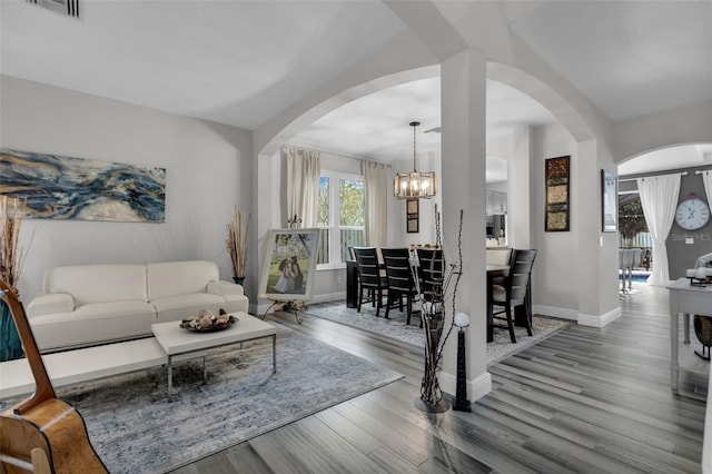 living room with wood-type flooring and a chandelier