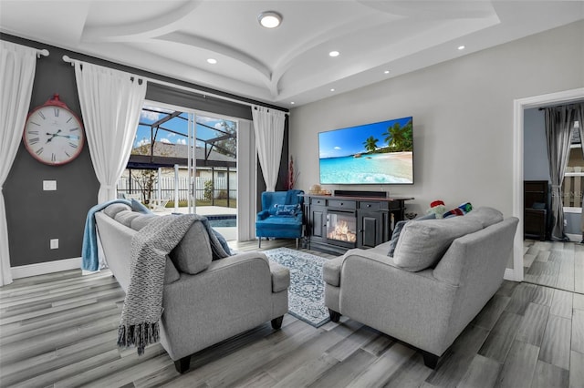 living room with vaulted ceiling and light wood-type flooring