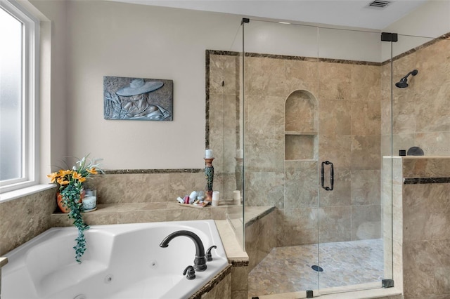 bathroom with separate shower and tub