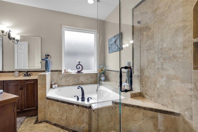 bathroom featuring tiled tub and vanity