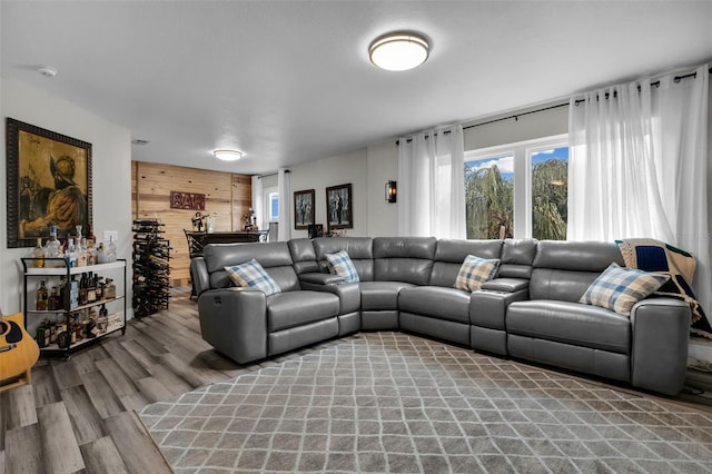 living room with wood-type flooring and wood walls