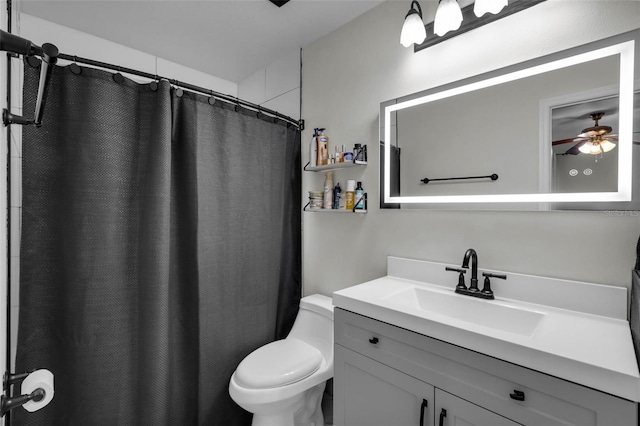 bathroom featuring vanity, ceiling fan, a shower with curtain, and toilet