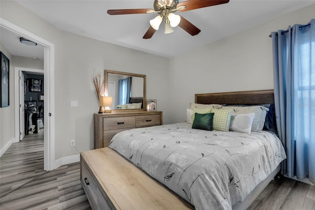 bedroom with hardwood / wood-style floors and ceiling fan