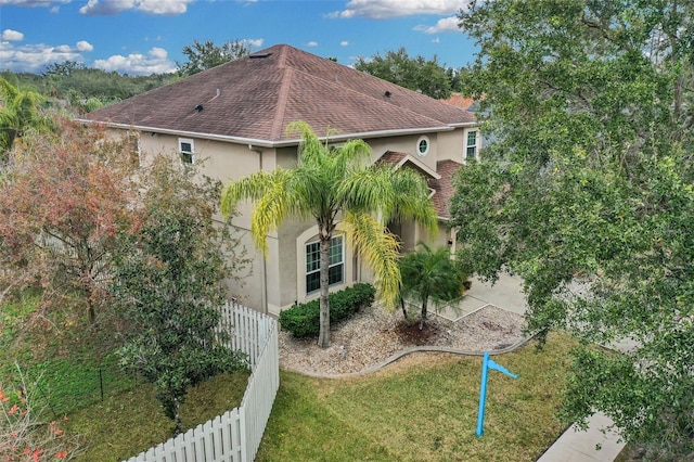 view of side of home with a lawn