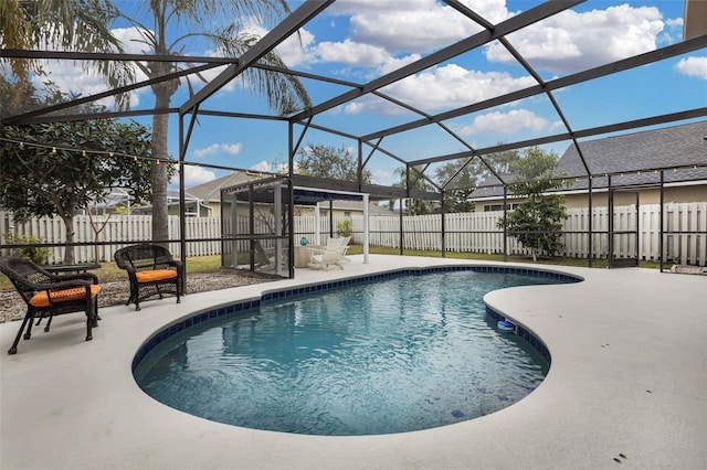 view of swimming pool with a patio and glass enclosure