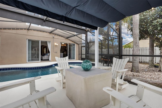 view of swimming pool featuring a patio and glass enclosure