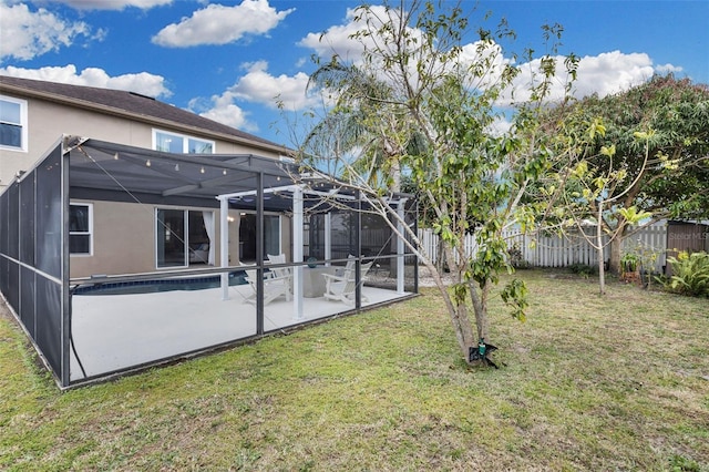 view of yard with a fenced in pool, glass enclosure, and a patio area