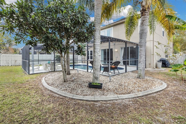 back of house with a fenced in pool, a lanai, and a patio