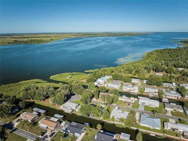 birds eye view of property with a water view, a forest view, and a residential view