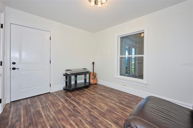 empty room with dark wood finished floors and baseboards