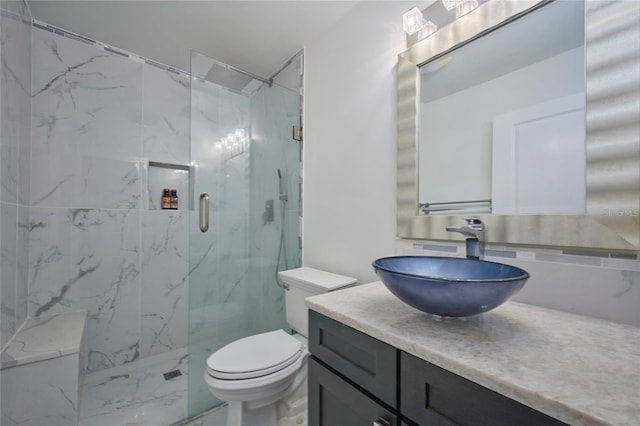 full bath with marble finish floor, vanity, a marble finish shower, and toilet